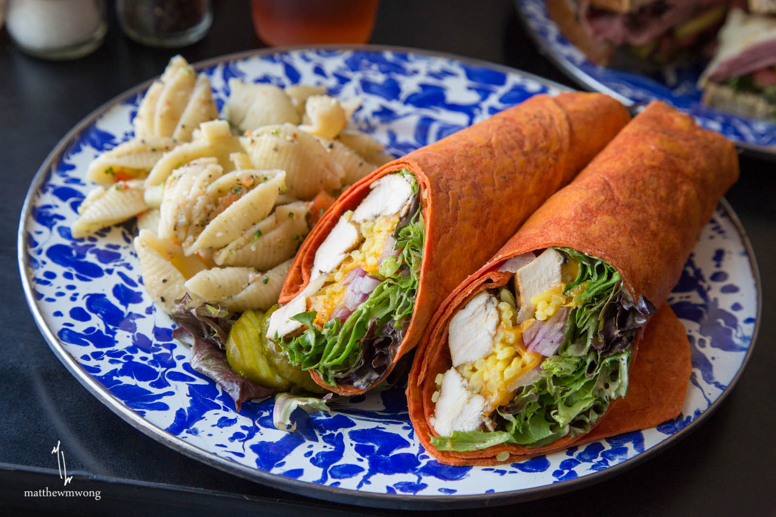 Spicy Chicken Wrap, Grilled chicken with melted cheddar, yellow rice, onions, tomatoes and mixed greens on a sundried tomato wrap with spicy ranch.