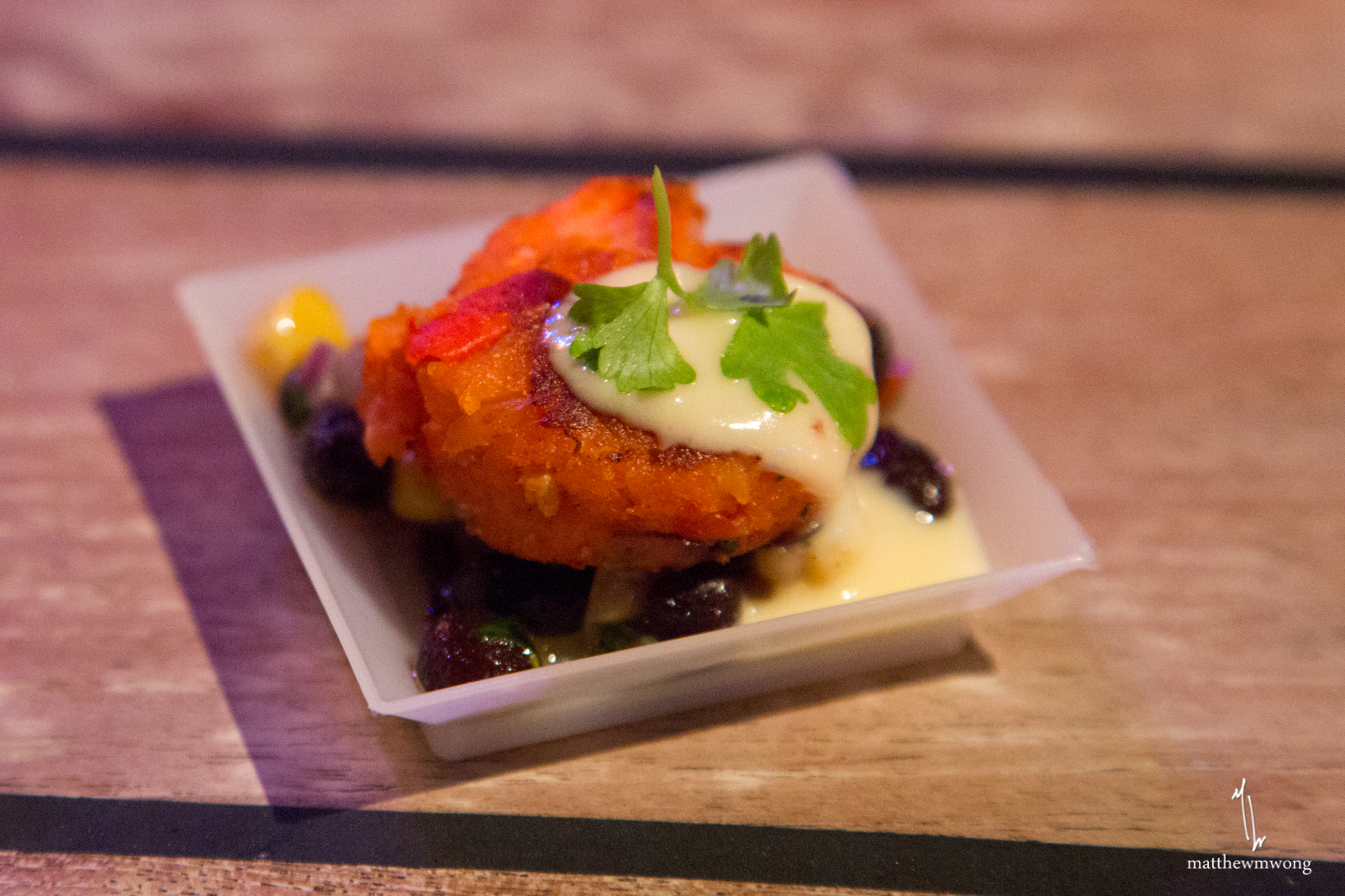 Lobster Cake with roast corn, black bean salsa, and cilantro orange beurre blanc by Tim Love