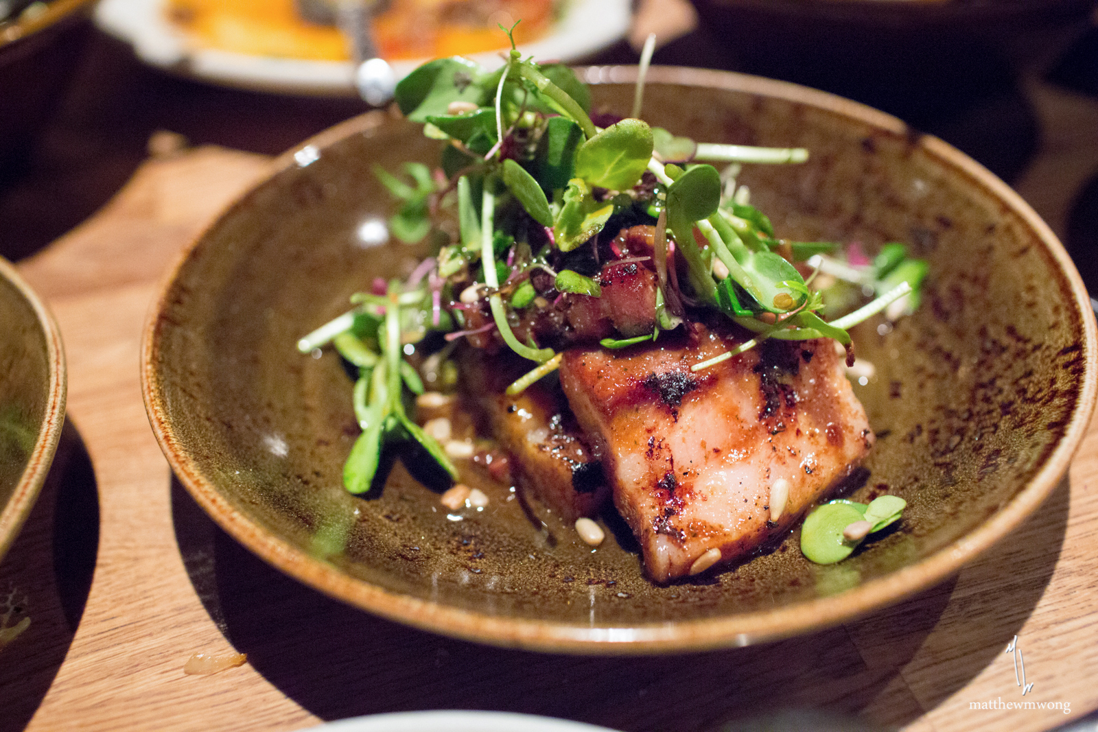 charred pork belly, spring onions, tangy jus, sunflower seeds