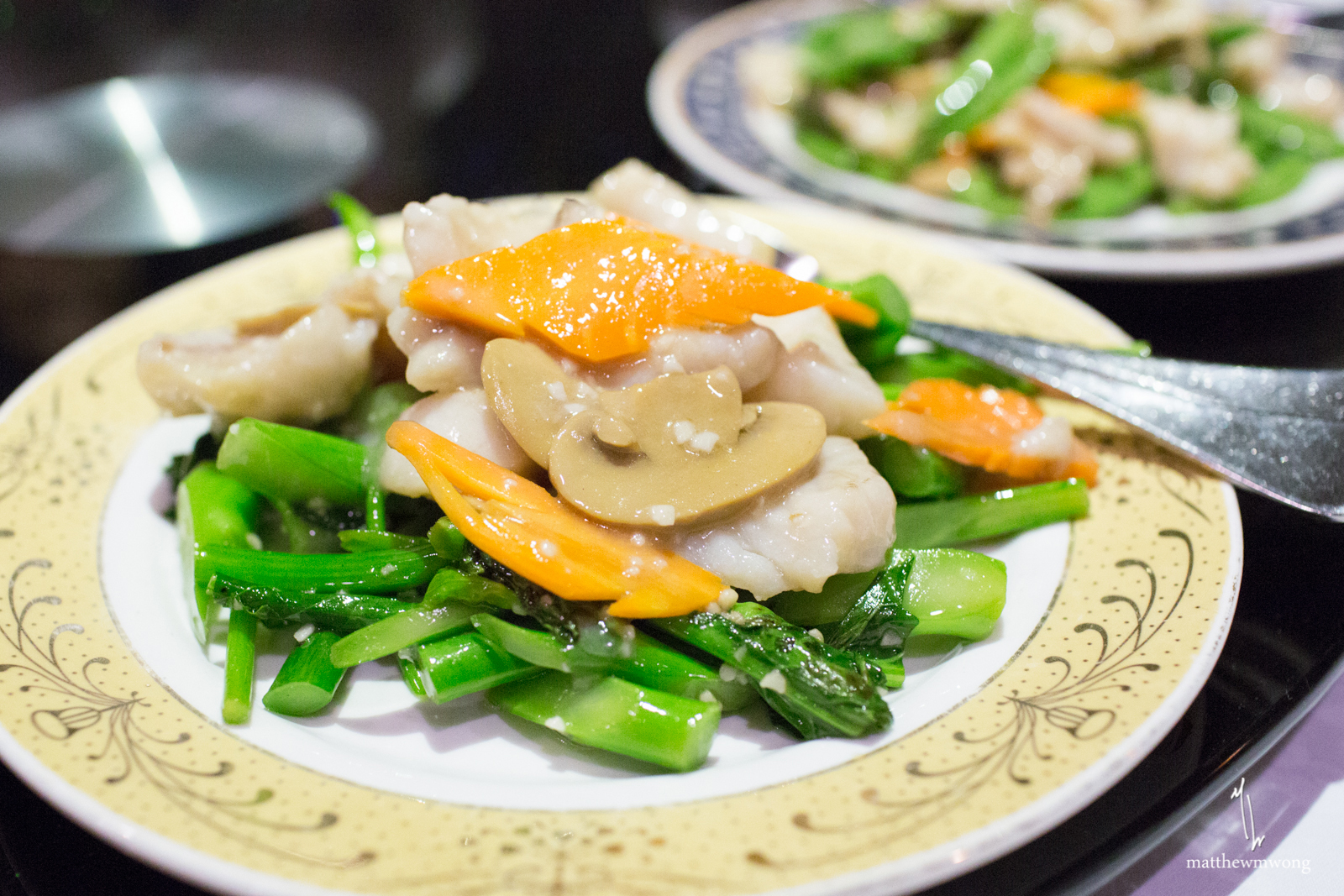 Slices of Rock Cod stir fried with mushrooms, carrots, and gailan