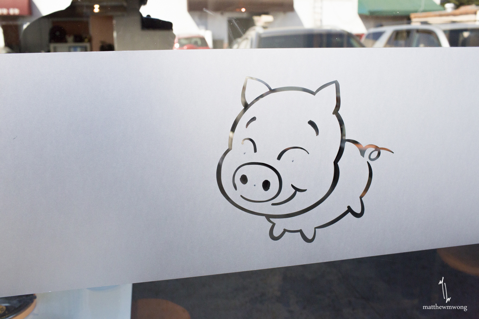 Outside store front. Funny pig. 