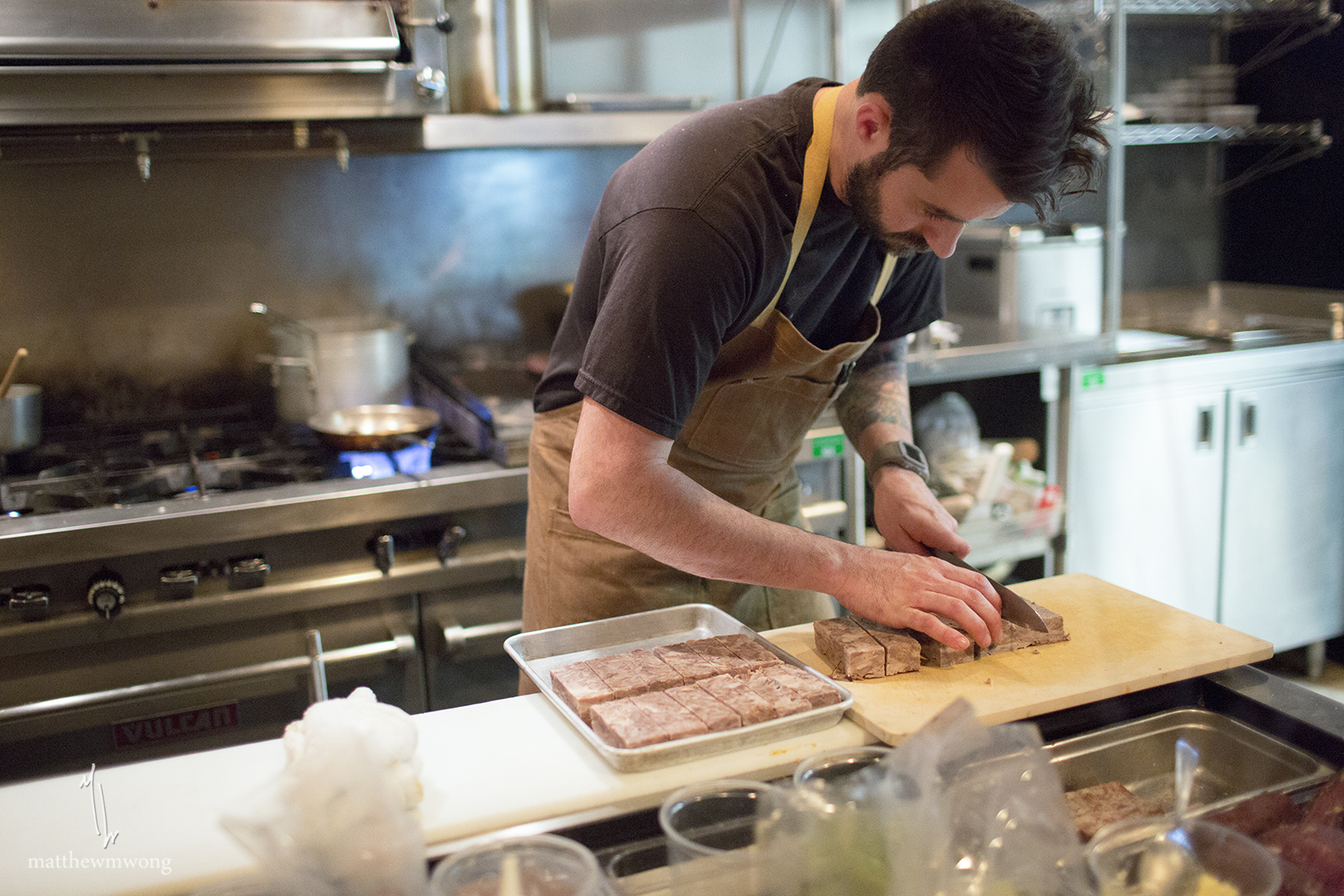 Chef Zach Meloy portioning out an ingredient for the night