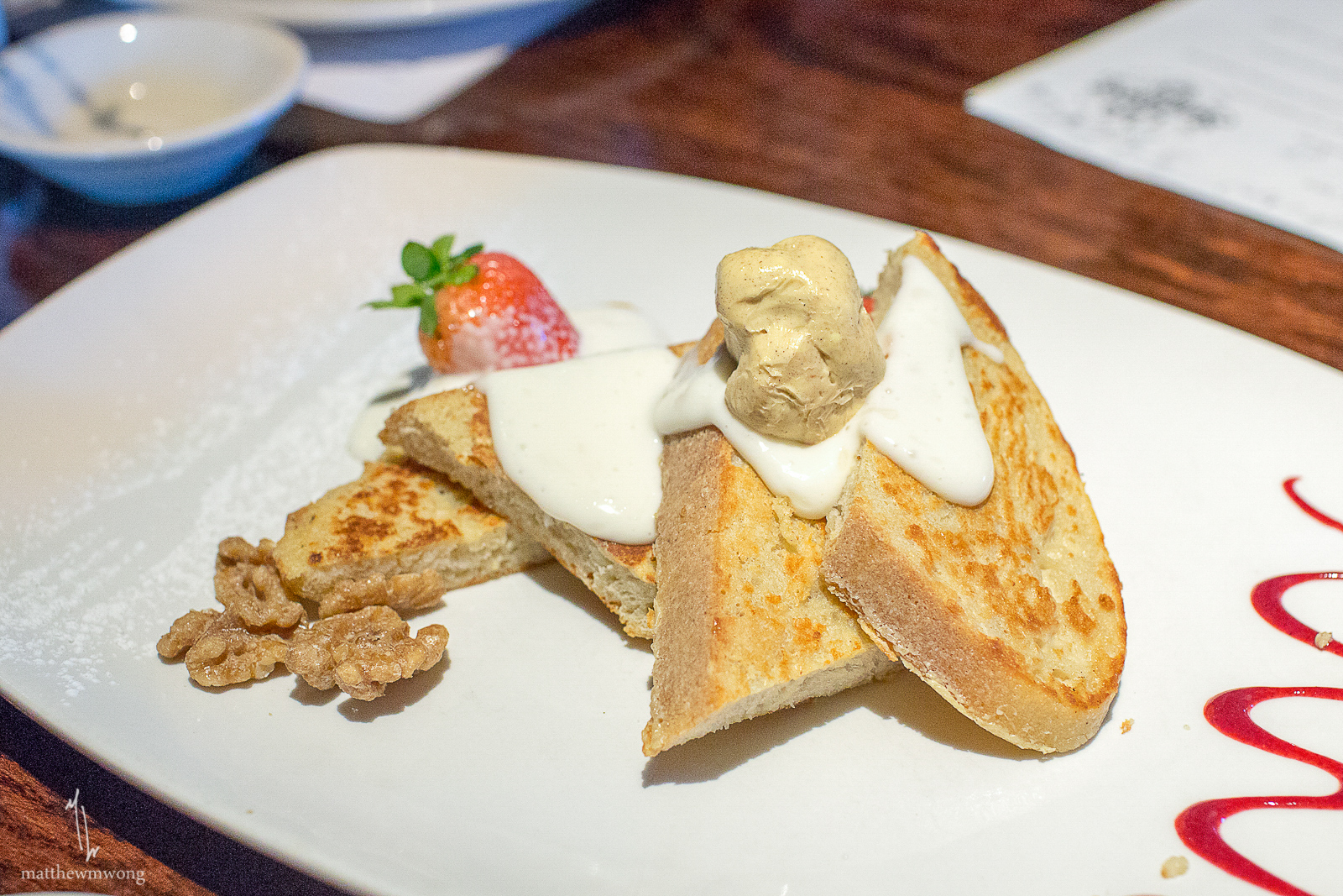 Strawberry French Toast - Cinnamon butter, candied walnuts, soy whipped cream, and raspberry sauce